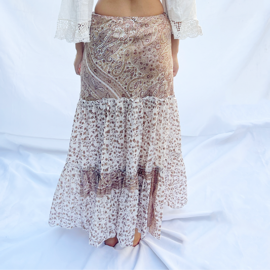 A delicate drawstring skirt made from vintage saris featuring a light floral pattern in shades of ivory and beige. The flowing design offers an elegant and adjustable fit.