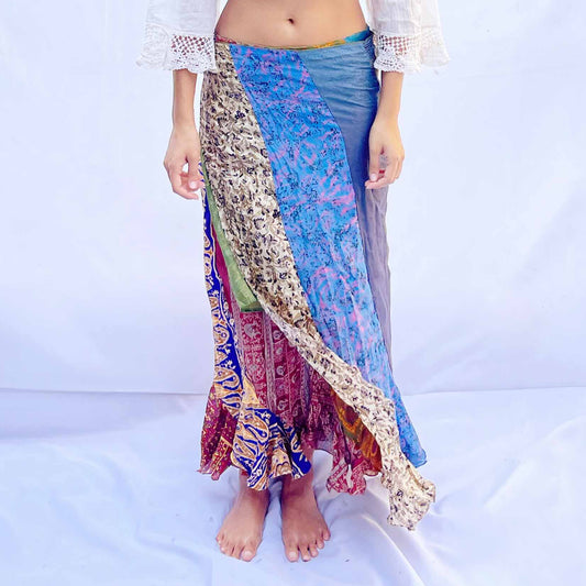 A reversible wrap skirt crafted from vintage sari fabric, featuring a mix of blue, beige, and multicoloured patterns. The flowing design offers versatility and style.