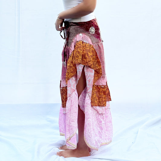 A patchwork skirt made from vintage saris, featuring soft pink, brown, and gold tones with intricate patterns. It includes an adjustable drawstring for a comfortable fit.